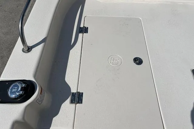 Slide: The Image of 2022 Carolina Skiff 21 LS boat deck with storage hatch and railing. - 9