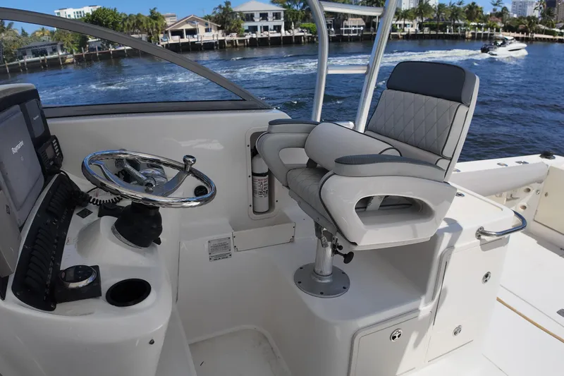 Slide: The Image of Helm of 2005 Boston Whaler 305 Conquest with steering wheel and captain's chair. - 10