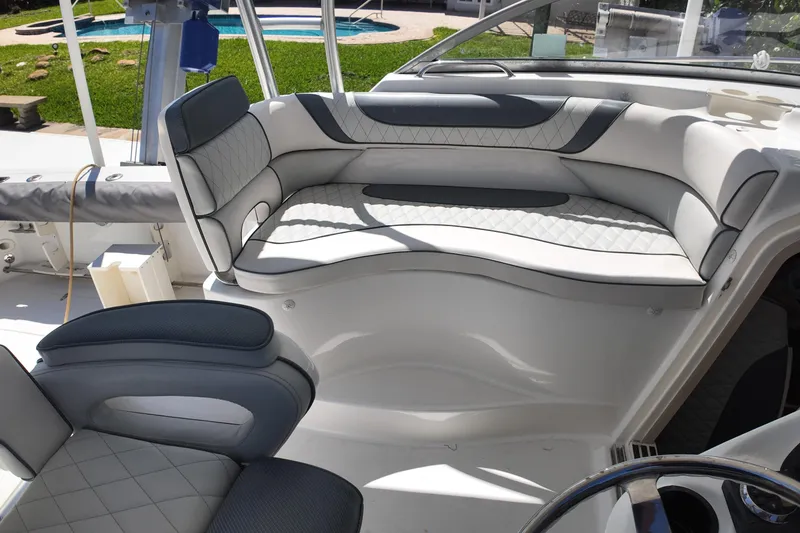 Slide: The Image of Interior seating of a 2005 Boston Whaler 305 Conquest boat, featuring cushioned seats. - 13