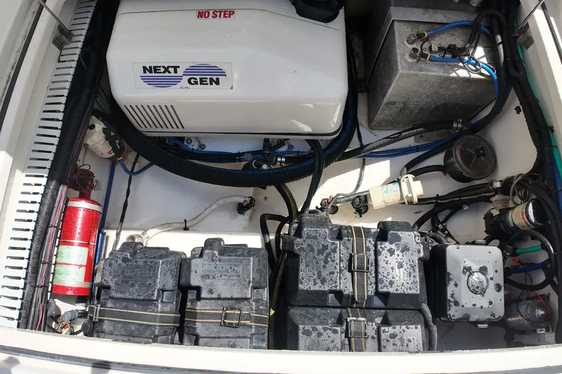 Slide: The Image of Engine compartment of a 2005 Boston Whaler 305 Conquest with generator and batteries. - 20