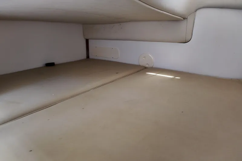 Slide: The Image of Interior cabin of 2005 Boston Whaler 305 Conquest, featuring beige upholstery. - 21