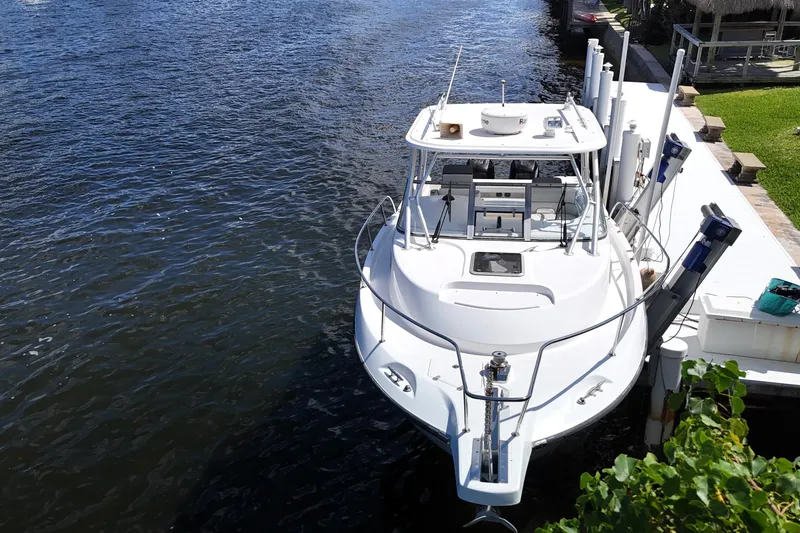 Slide: The Image of 2005 Boston Whaler 305 Conquest docked by the water, aerial view. - 8