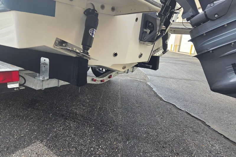 Slide: The Image of 2024 Pioneer 202 Islander boat on trailer, showcasing rear hull and motor details. - 14