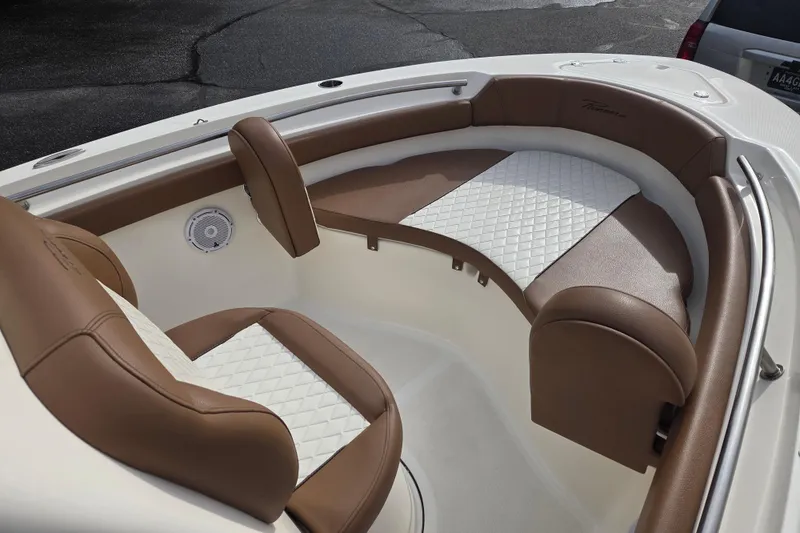 Slide: The Image of 2024 Pioneer 202 Islander boat interior with brown and white cushioned seating. - 3
