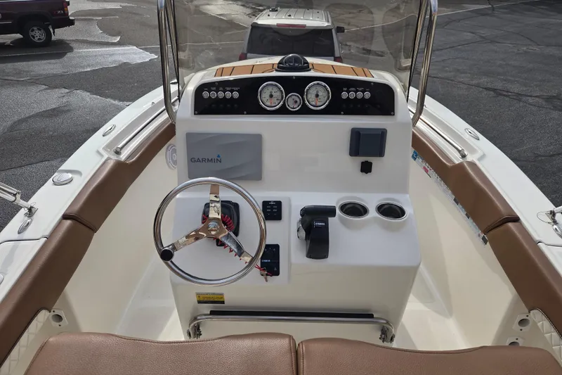 Slide: The Image of 2024 Pioneer 202 Islander boat dashboard with Garmin navigation and steering wheel. - 6