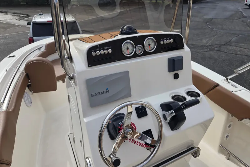 Slide: The Image of 2024 Pioneer 202 Islander boat dashboard with Garmin navigation system and steering wheel. - 7