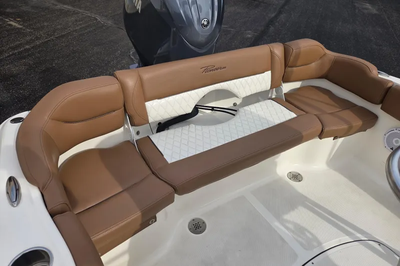 Slide: The Image of 2024 Pioneer 202 Islander boat interior with brown and white cushioned seating. - 8