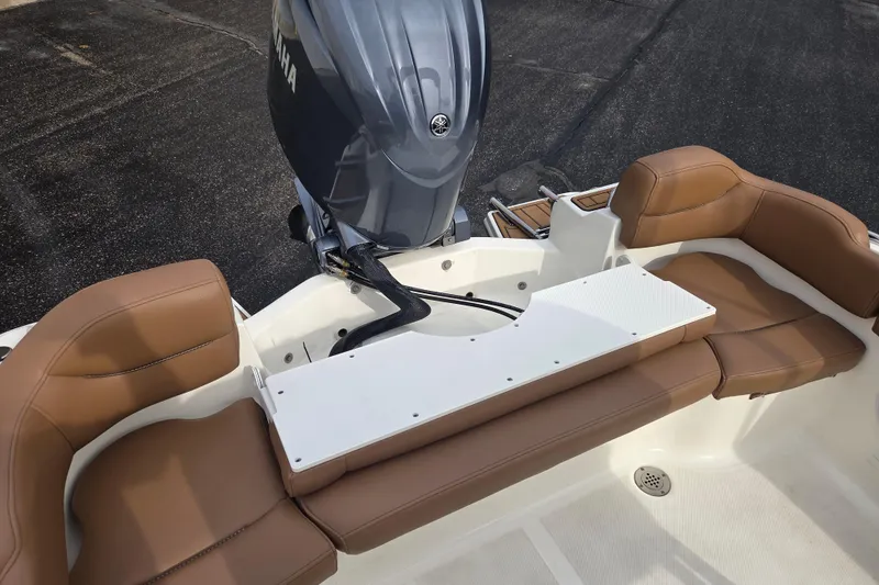 Slide: The Image of 2024 Pioneer 202 Islander boat interior with brown seating and Yamaha outboard motor. - 9