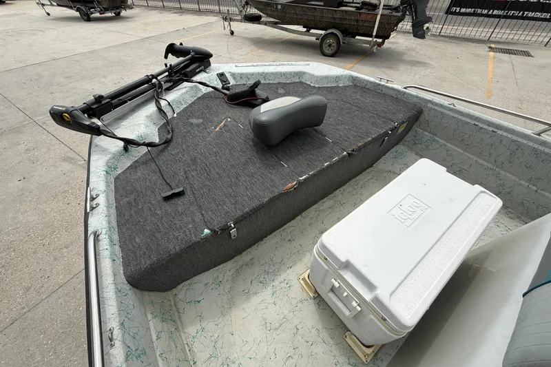 Slide: The Image of 1998 Predator 18ft CC boat interior with trolling motor and cooler on deck. - 8