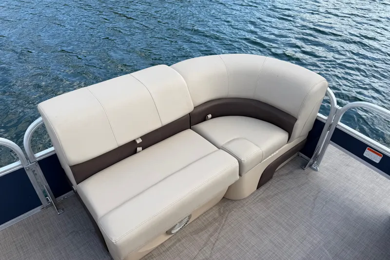 Slide: The Image of 2019 Sun Tracker Party Barge 22 Sport Fish boat seating with beige upholstery on water. - 12