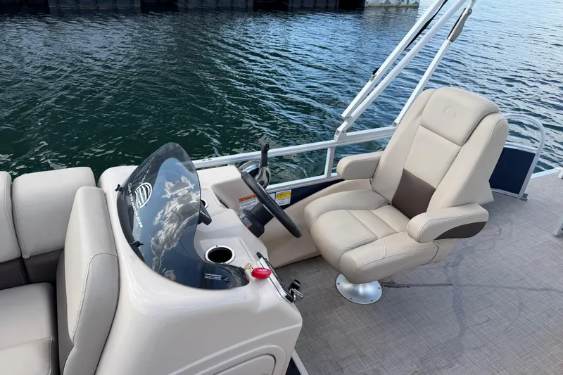 Slide: The Image of 2019 Sun Tracker Party Barge 22 Sport Fish boat interior with captain's chair and steering console. - 15