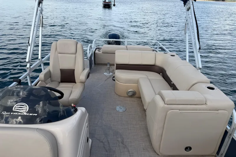 Slide: The Image of 2019 Sun Tracker Party Barge 22 Sport Fish pontoon boat on water, featuring spacious seating. - 16