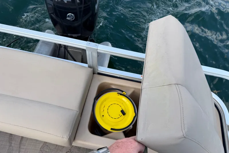 Slide: The Image of 2019 Sun Tracker Party Barge 22 Sport Fish with storage compartment open on the water. - 18