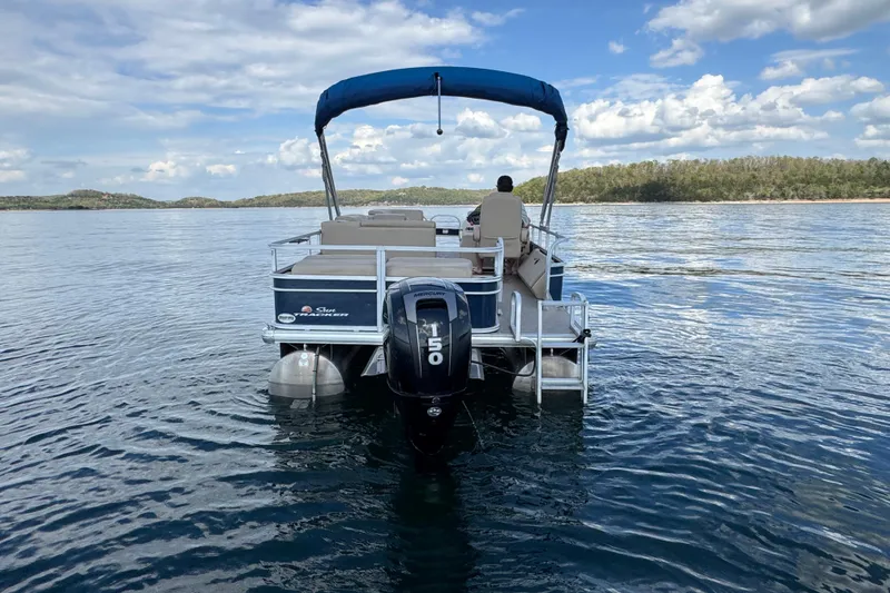 Slide: The Image of 2019 Sun Tracker Party Barge 22 Sport Fish on a serene lake under a blue sky. - 5
