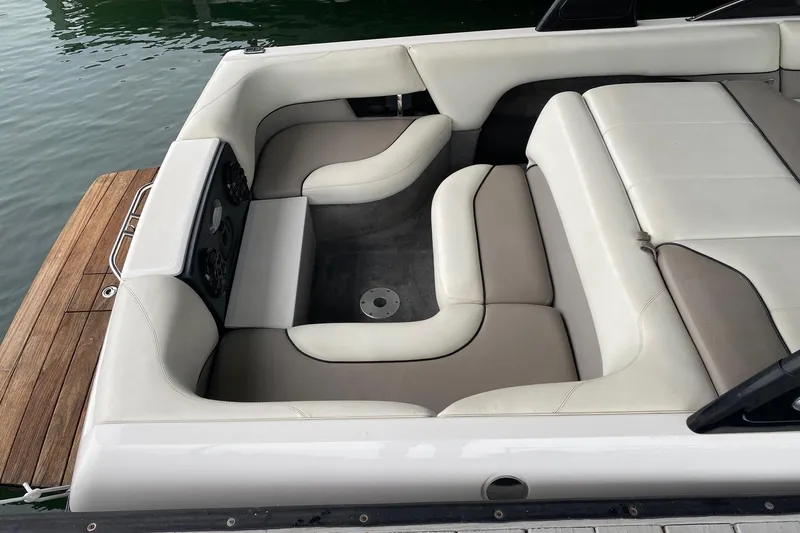 Slide: The Image of 2004 Malibu Wakesetter 21 XTi boat interior with white and beige seating. - 4