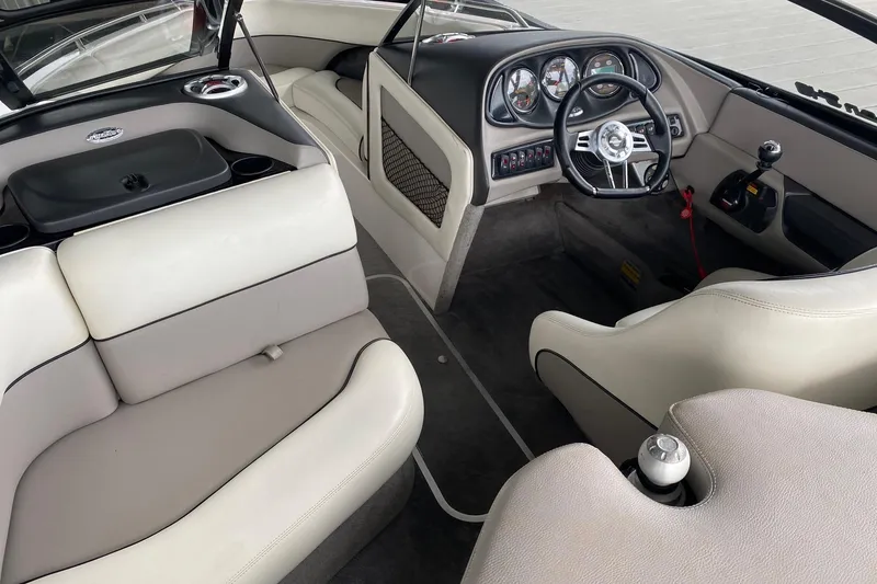 Slide: The Image of Interior of a 2004 Malibu Wakesetter 21 XTi boat, featuring sleek seating and dashboard. - 6