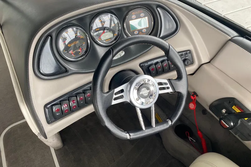 Slide: The Image of Dashboard of a 2004 Malibu Wakesetter 21 XTi boat with steering wheel and gauges. - 7