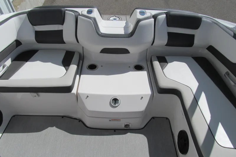 Slide: The Image of 2024 Yamaha Boats AR195 interior seating with modern design and cup holders. - 12