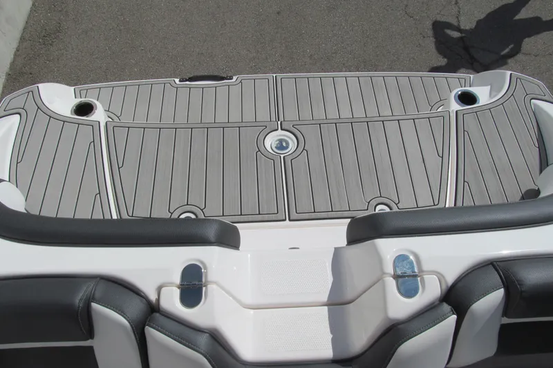 Slide: The Image of 2024 Yamaha AR195 boat swim platform with sleek gray decking and cup holders. - 13