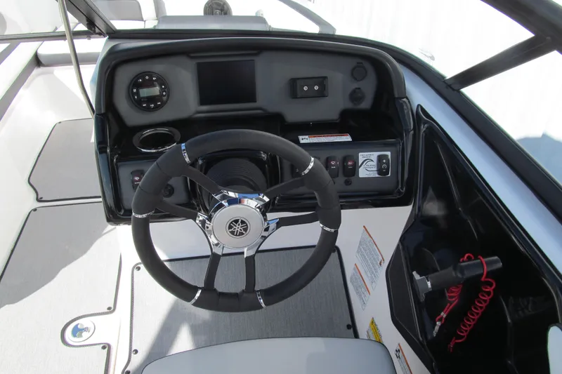 Slide: The Image of 2024 Yamaha Boats AR195 dashboard with steering wheel and control panel. - 6