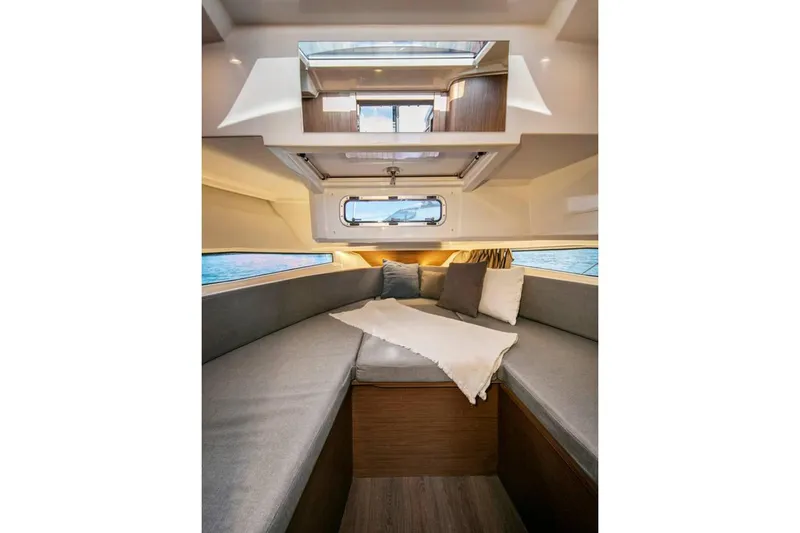 Slide: The Image of 2024 Jeanneau NC Sport 895 interior with open mini fridge, showcasing modern design. - 12