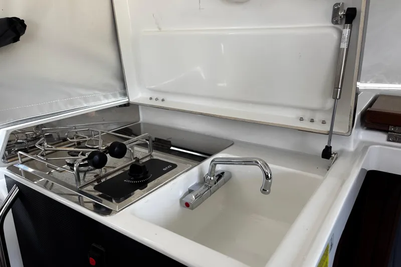 Slide: The Image of 2024 Jeanneau NC Sport 895 boat kitchen with stove and sink. - 21