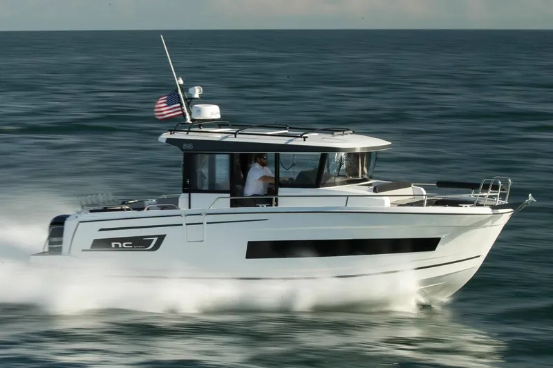 Slide: The Image of 2024 Jeanneau NC Sport 895 boat with dual outboard motors, rear view. - 3