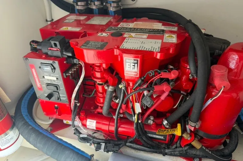 Slide: The Image of Engine compartment of 2024 Jeanneau NC Sport 895, featuring a red multiport EFI system. - 32