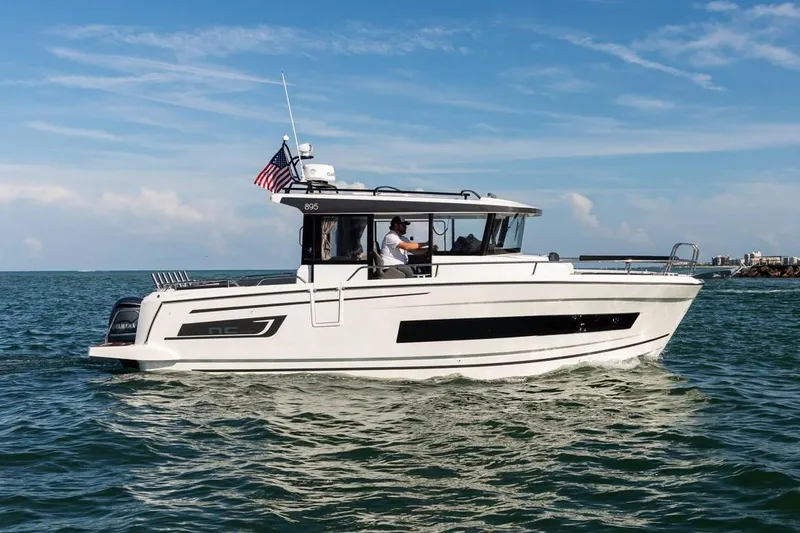 Slide: The Image of 2024 Jeanneau NC Sport 895 boat deck with sleek design and spacious layout. - 6