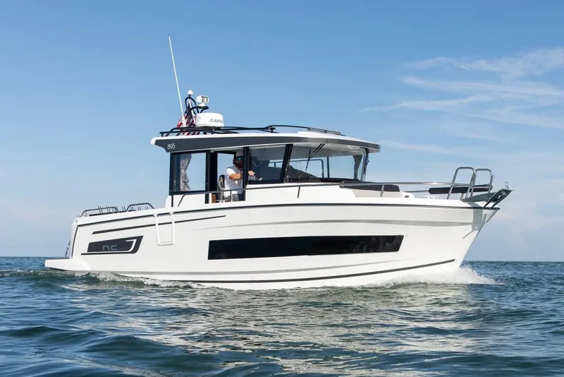 Slide: The Image of 2024 Jeanneau NC Sport 895 boat deck with seating, railing, and clear sky background. - 7