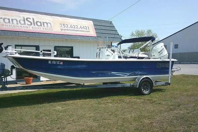 The Image of 2015 Carolina Skiff 2180 DLX boat on trailer, parked outside Grand Slam Boats dealership. - 1