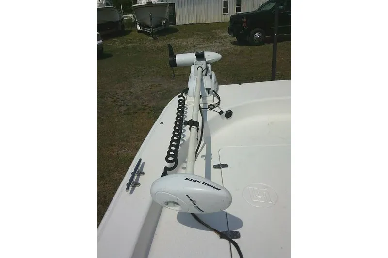 Slide: The Image of 2015 Carolina Skiff 2180 DLX boat with trolling motor on deck. - 10