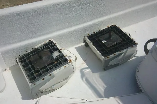 Slide: The Image of 2015 Carolina Skiff 2180 DLX boat interior with two battery holders on deck. - 11
