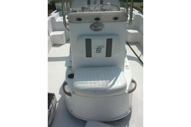 Slide: The Image of 2015 Carolina Skiff 2180 DLX boat interior with cushioned seating and steering console. - 12