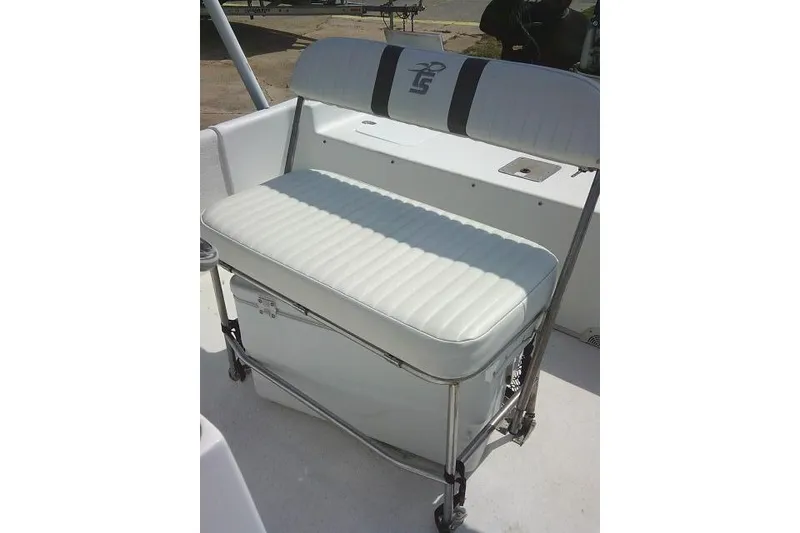 Slide: The Image of 2015 Carolina Skiff 2180 DLX boat seat with integrated cooler and cushioned backrest. - 13