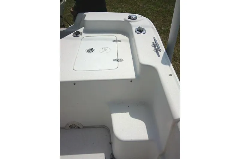 Slide: The Image of 2015 Carolina Skiff 2180 DLX boat interior with storage compartment and cleats. - 14