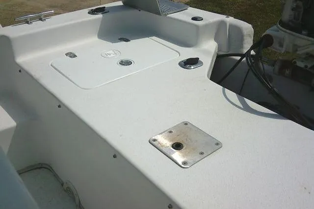Slide: The Image of 2015 Carolina Skiff 2180 DLX boat deck with storage compartments and control panel. - 15