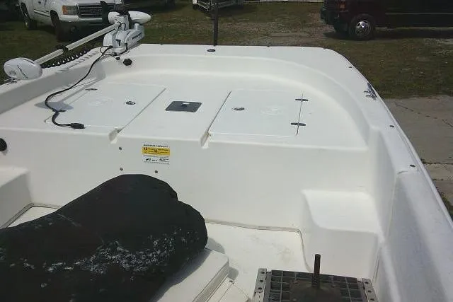 Slide: The Image of 2015 Carolina Skiff 2180 DLX boat deck with storage compartments and trolling motor. - 18