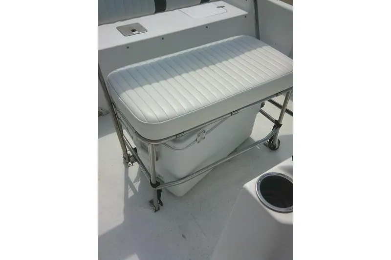 Slide: The Image of 2015 Carolina Skiff 2180 DLX boat interior with cushioned bench seat and storage. - 19