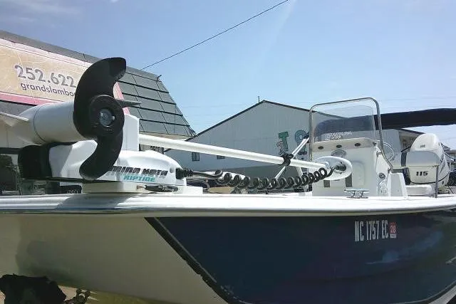 Slide: The Image of 2015 Carolina Skiff 2180 DLX boat with trolling motor, docked outdoors. - 3
