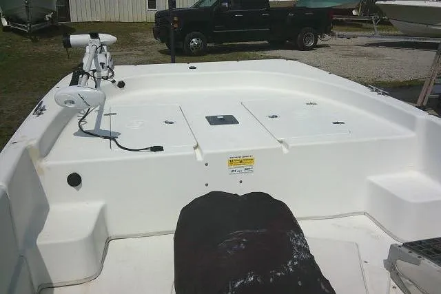 Slide: The Image of 2015 Carolina Skiff 2180 DLX boat deck with storage compartments and trolling motor. - 9