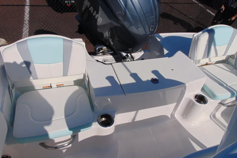 Slide: The Image of 2025 Robalo R180 Center Console boat interior with seating and Yamaha engine. - 10