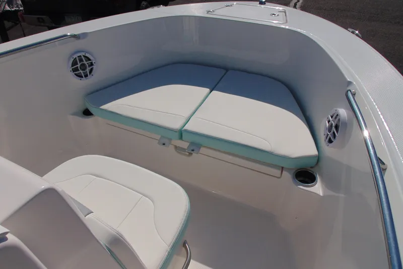Slide: The Image of 2025 Robalo R180 Center Console boat interior with cushioned seating and cup holders. - 11