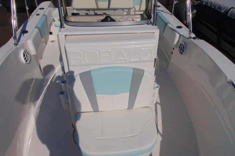 Slide: The Image of 2025 Robalo R180 Center Console boat interior with cushioned seating and console details. - 12