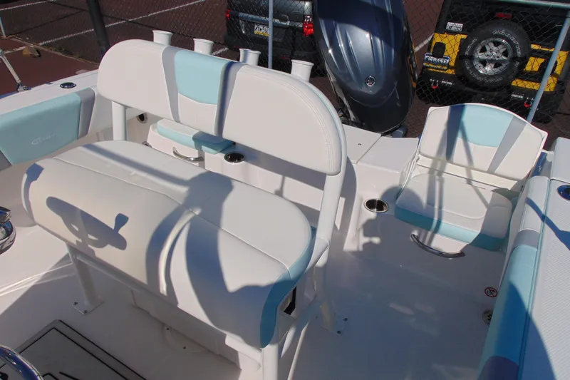 Slide: The Image of 2025 Robalo R180 Center Console boat interior with white and blue seating. - 16