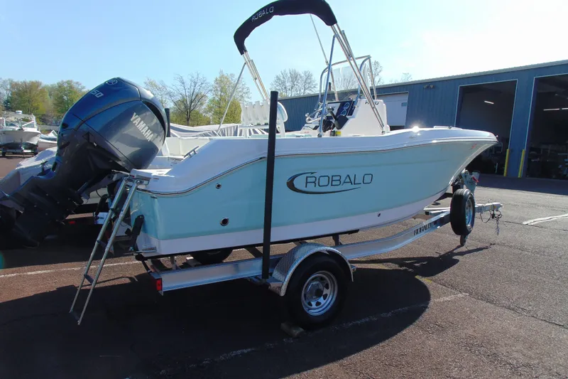 Slide: The Image of 2025 Robalo R180 Center Console boat on trailer with Yamaha engine. - 3