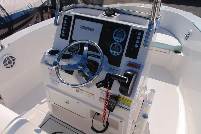 Slide: The Image of 2025 Robalo R180 Center Console boat dashboard with steering wheel and controls. - 6