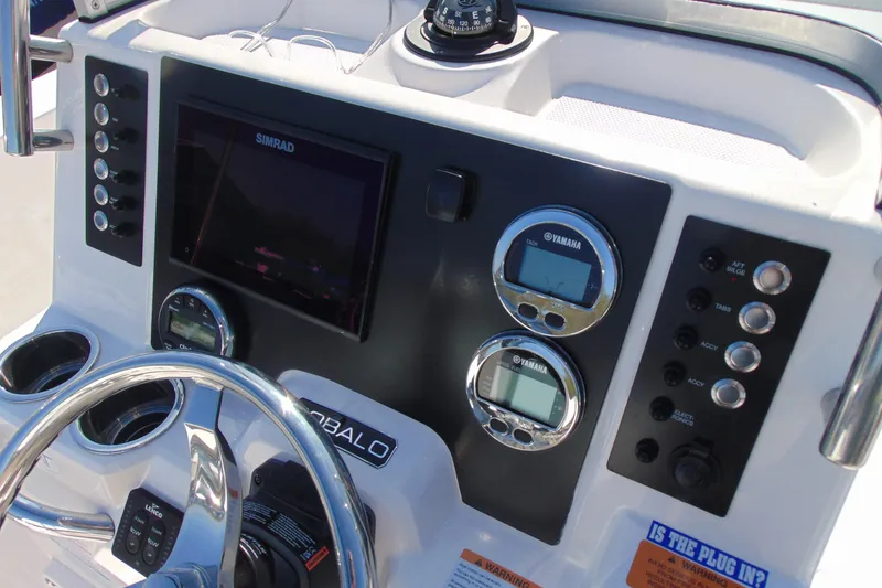 Slide: The Image of 2025 Robalo R180 Center Console dashboard with Simrad display and Yamaha gauges. - 7