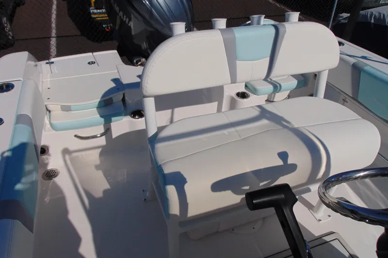 Slide: The Image of 2025 Robalo R180 Center Console boat interior with white and blue seating. - 9
