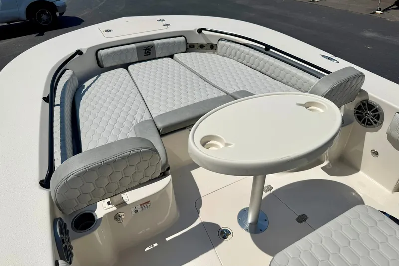 Slide: The Image of 2026 Carolina Skiff 22 Ultra Elite boat interior with cushioned seating and round table. - 11